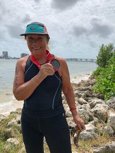 At 69, Annelie, with a big Triathlon medal  