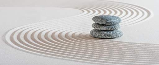 Stones in sand with swirls in it