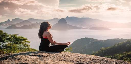 Woman meditating on a mountain