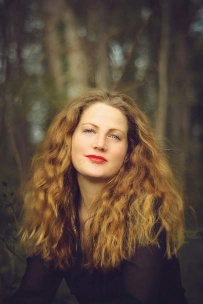 Young woman with long red hair wearing red lipstick